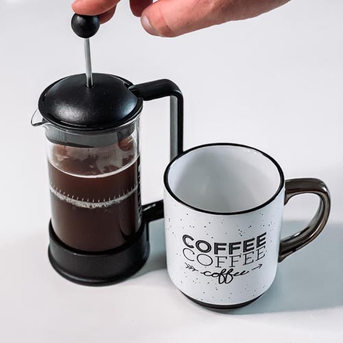 Pressing plunger down on french press